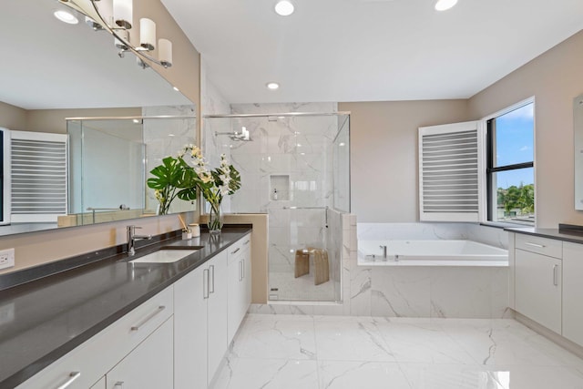 bathroom with vanity and independent shower and bath