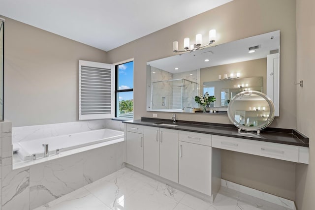 bathroom with vanity and independent shower and bath