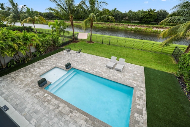 view of pool featuring a water view, a yard, and a patio