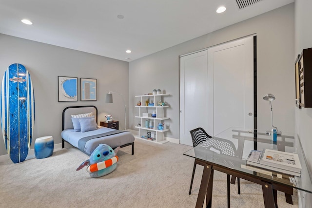 bedroom featuring a closet and light colored carpet