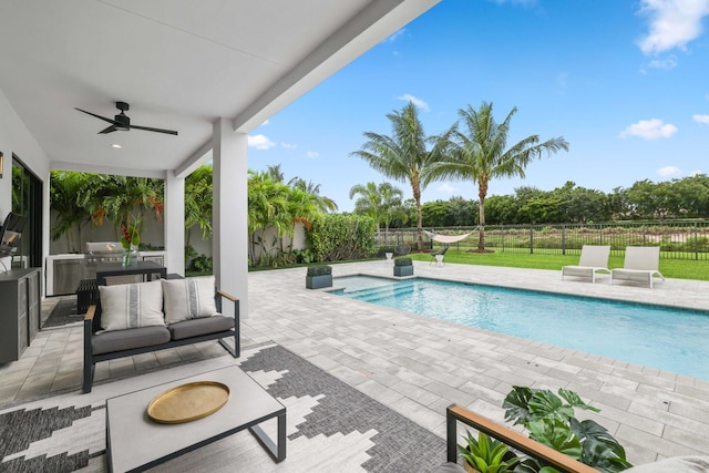 view of swimming pool featuring ceiling fan, an outdoor hangout area, and a patio