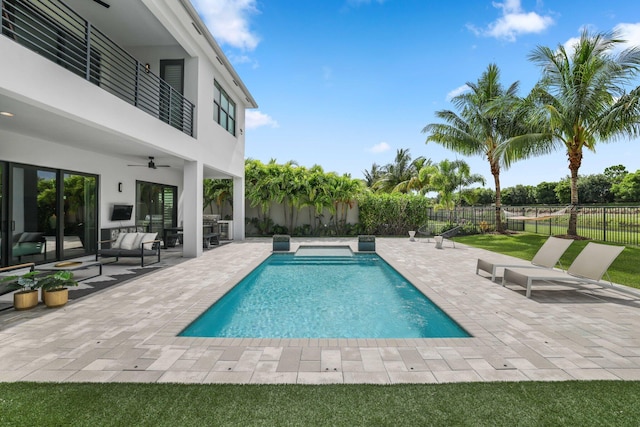 view of swimming pool with ceiling fan, an outdoor living space, and a patio