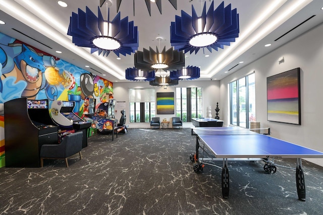 playroom featuring a raised ceiling