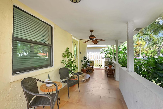 balcony featuring ceiling fan and a porch