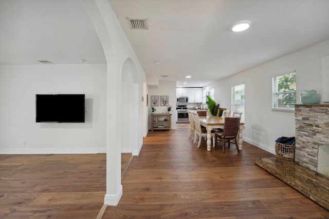 dining room with dark hardwood / wood-style flooring