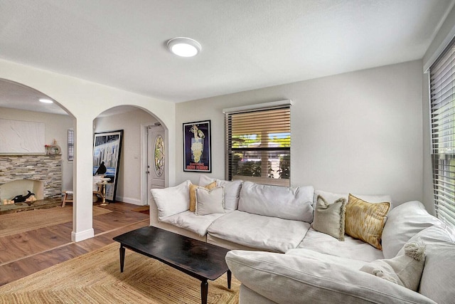 living room with hardwood / wood-style flooring and a textured ceiling