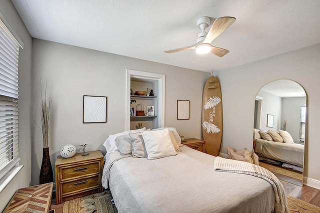 bedroom with hardwood / wood-style floors and ceiling fan