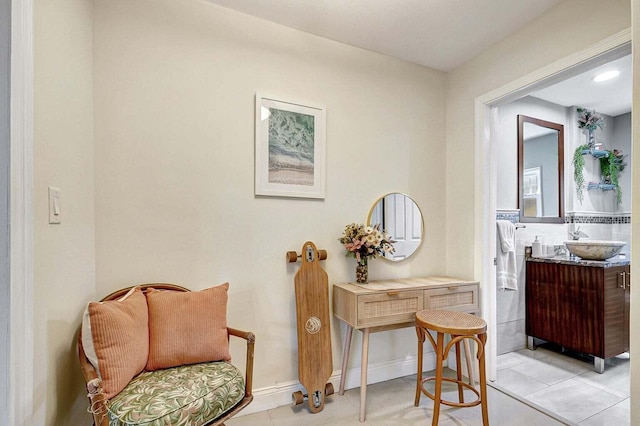 sitting room with sink and light tile patterned floors