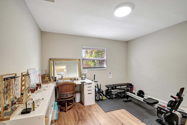 exercise area with light hardwood / wood-style floors