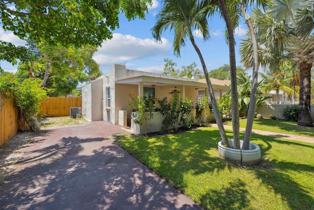 view of front of house featuring a front yard and central air condition unit