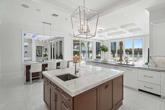 kitchen with backsplash, beam ceiling, sink, and custom exhaust hood