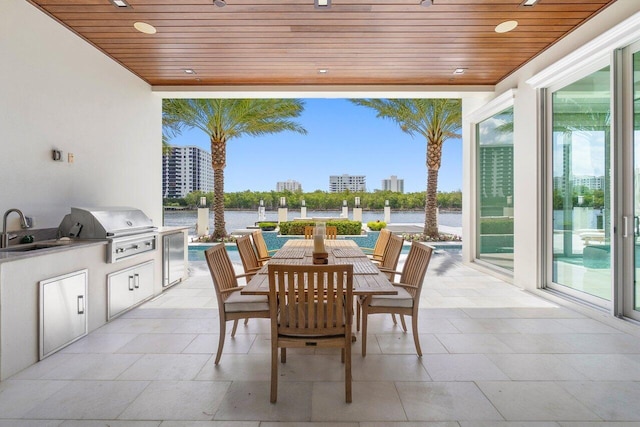 view of swimming pool featuring a water view, a patio, and pool water feature