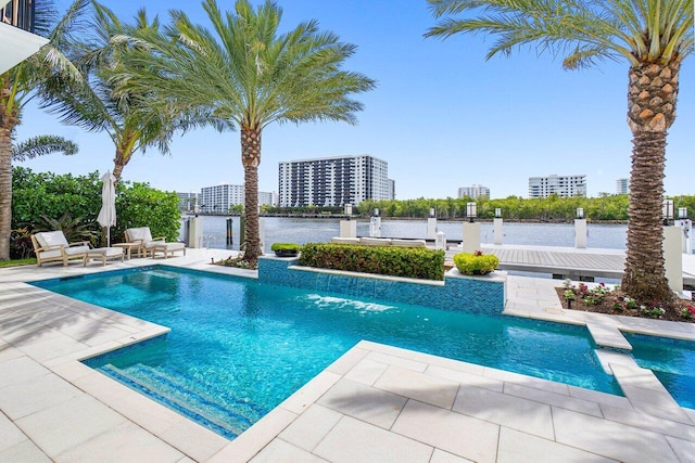 view of pool with a water view, pool water feature, and a patio area