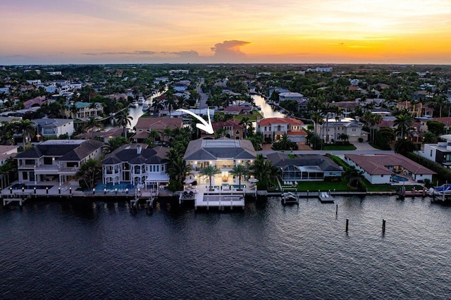 aerial view at dusk with a water view