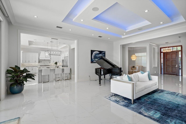 living room featuring crown molding and a raised ceiling