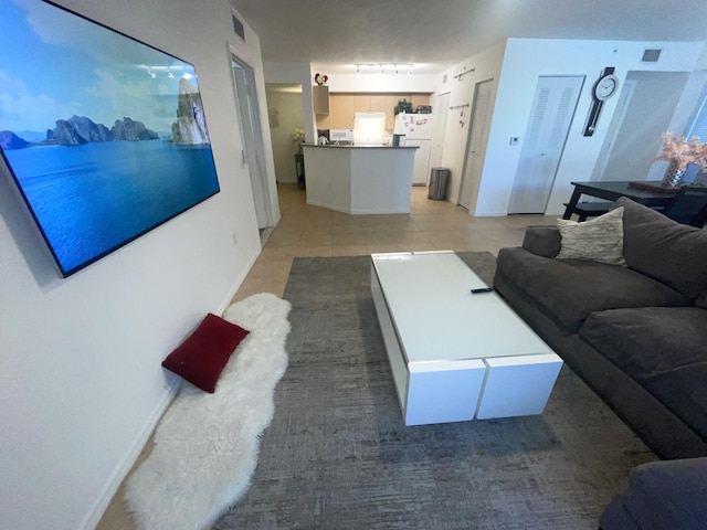 tiled living room with rail lighting