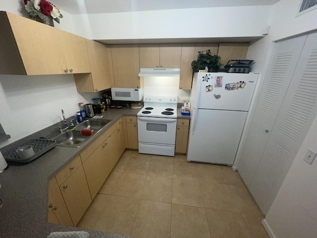 kitchen with sink, light tile patterned floors, white appliances, and light brown cabinets