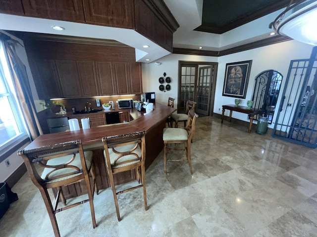 kitchen with backsplash, french doors, and ornamental molding