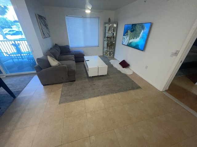 tiled living room featuring ceiling fan