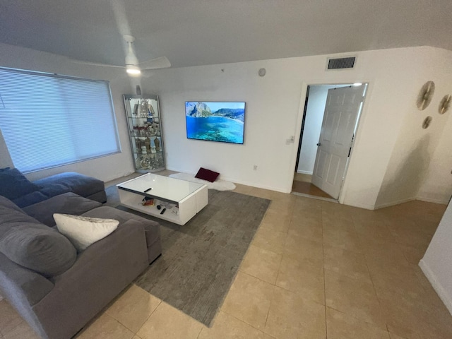 living room featuring ceiling fan and light tile patterned floors