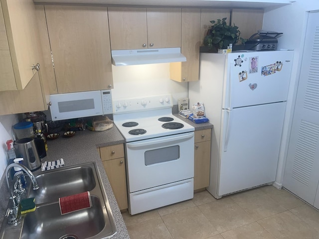 kitchen with light tile patterned flooring, white appliances, sink, and light brown cabinetry