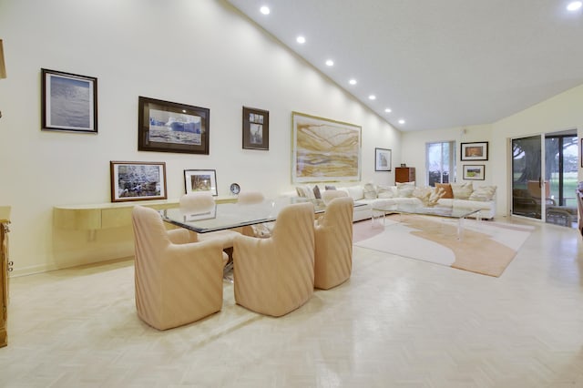 living room featuring high vaulted ceiling and light parquet floors