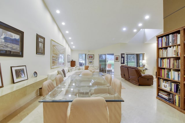 dining room featuring high vaulted ceiling