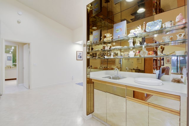 bathroom featuring sink and lofted ceiling