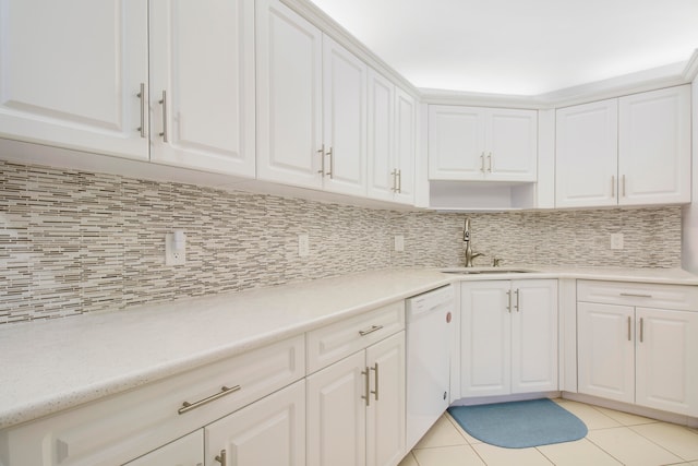 kitchen featuring white dishwasher, decorative backsplash, and white cabinets