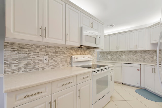 kitchen featuring decorative backsplash, light tile patterned floors, white appliances, and white cabinets