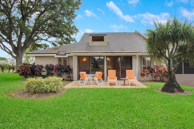 back of property with a lawn and a patio