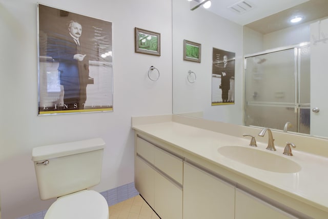 bathroom with walk in shower, vanity, tile patterned floors, and toilet