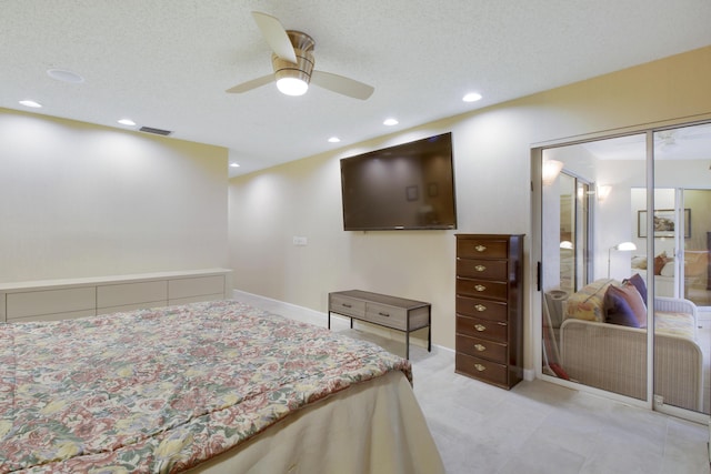 bedroom featuring ceiling fan, a textured ceiling, and a closet