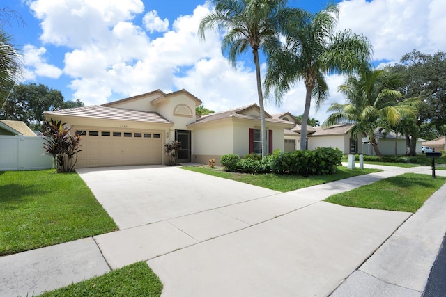 view of front of house with a garage and a front lawn