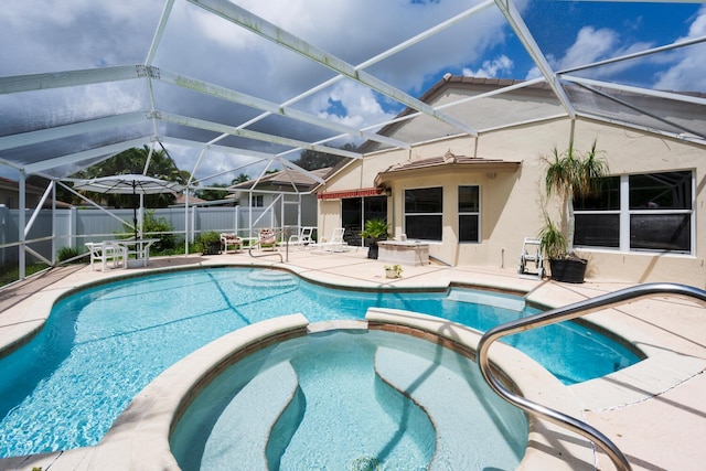 view of swimming pool with glass enclosure, an in ground hot tub, and a patio