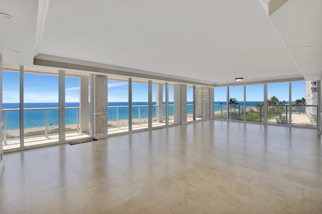 tiled empty room with expansive windows, a beach view, and a water view