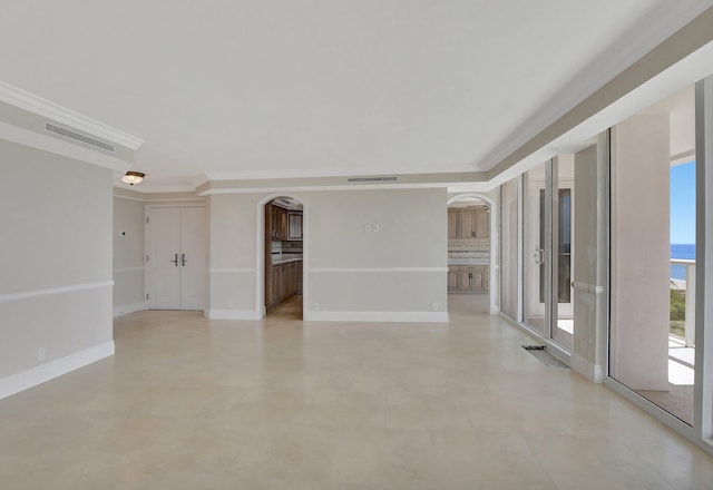 unfurnished room featuring crown molding and a water view