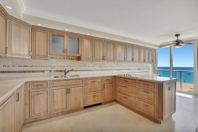 kitchen with tasteful backsplash, sink, ornamental molding, a water view, and black electric cooktop