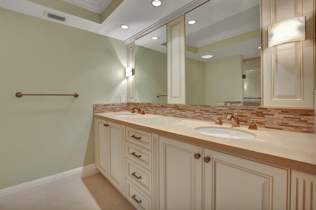 bathroom featuring vanity, backsplash, crown molding, and tile patterned floors