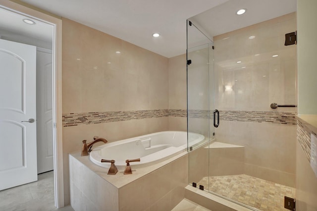 bathroom featuring independent shower and bath and tile patterned flooring