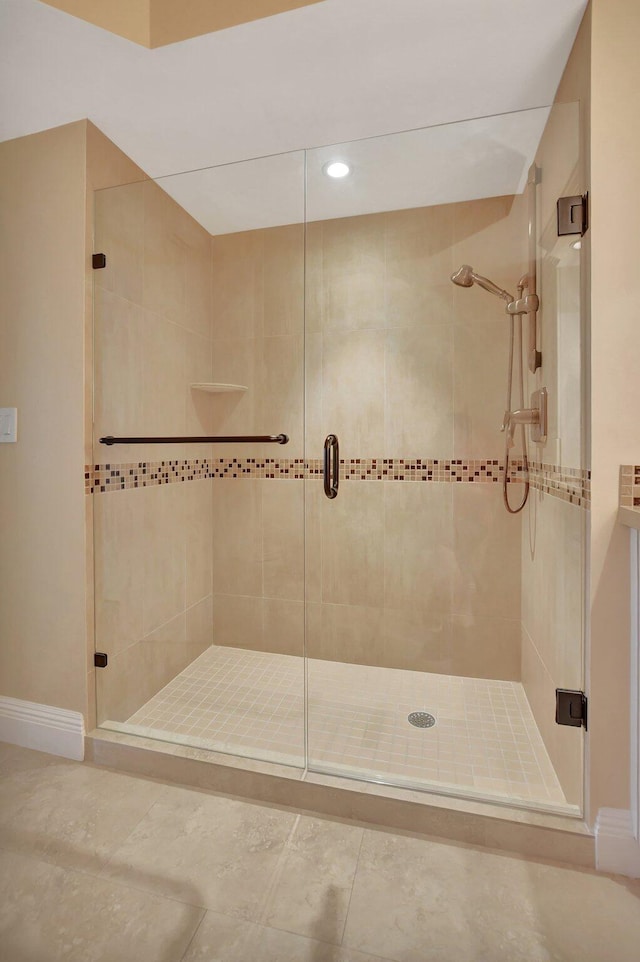 bathroom featuring a shower with shower door