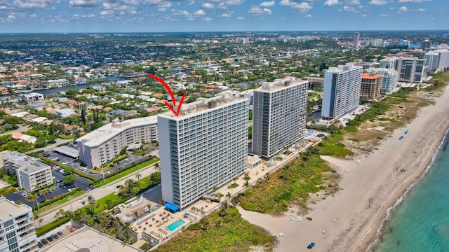 birds eye view of property featuring a water view and a view of the beach