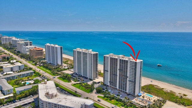 drone / aerial view featuring a beach view and a water view