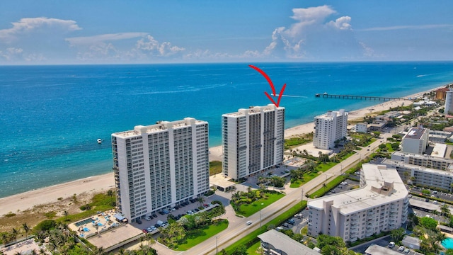 drone / aerial view with a water view and a beach view