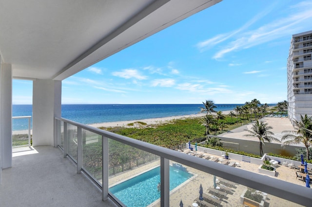 balcony featuring a view of the beach and a water view