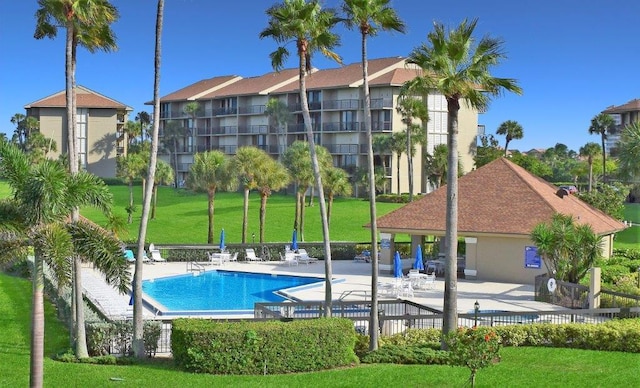 view of swimming pool featuring a lawn and a patio