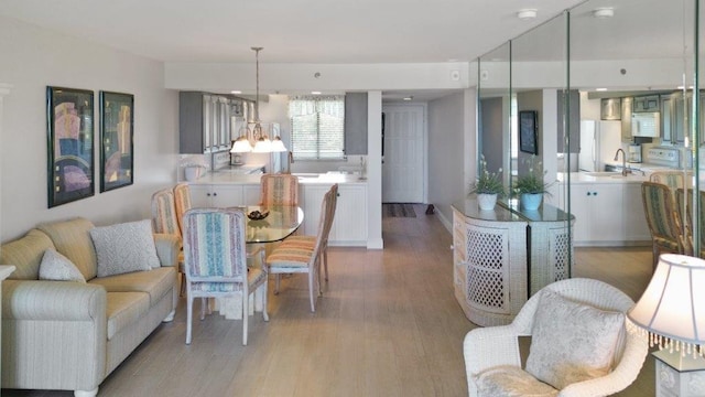 dining room featuring sink and light hardwood / wood-style floors