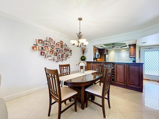 tiled dining space featuring ceiling fan with notable chandelier and ornamental molding