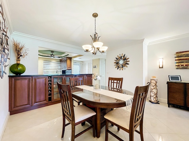 tiled dining space featuring sink, ceiling fan with notable chandelier, and ornamental molding