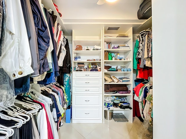 spacious closet with light tile patterned floors